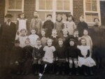 Great Ellingham School. Possibly early 1920s. Mr Field Headmaster. Mrs Overton (nee Ethel Beales) Teacher. Children back row (next to Mr Field) Lily Key, unknown, unknown, Nelly Morter, possibly Josie Sadd, Claud Lebbell. Middle row (next to Mr Field) unknown, unknown, possible Molly Giles, possibly Ray Neave, possibly Myrtle Beales, Herbert Saunders, Lily Hammond. Front row (next to Mr Field) Falcon Lee Billum, George Leverett, Lenny Bowen, Clementine Dorothy Wilkins Skipper, ? Harper, unknown, Olive Saunders. Names as remembered by Herbert Skipper. Photograph Sarah Brand