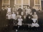 Great Ellingham School. Possibly early 1920s. Mr Field Headmaster. Mrs Overton (nee Ethel Beales) Teacher. Children back row (next to Mr Field) Lily Key, unknown, unknown, Nelly Morter, possibly Josie Sadd, possibly Claude Lebbell. Middle row (next to Mr Field) unknown, unknown, possible Molly Giles, possibly Ray Neave, possibly Myrtle Beales, Herbert Saunders, Lily Hammond. Front row (next to Mr Field) Falcon Lee Billum, George Leverett, Lenny Bowen, Clementine Dorothy Wilkins Skipper, ? Harper, unknown, Olive Saunders. Names as remembered by Herbert Skipper. Photograph Sarah Brand