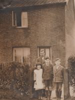 Frank Newby with three of his children (facing the photograph from right to left sons Basil and Ben and next along one of his daughters. Thought to have been taken in the late 1930s at their home in Watton Road. Photograph courtesy of Sue Gent