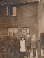Frank Newby with three of his children (facing the photograph from right to left sons Basil and Ben and next along one of his daughters. Thought to have been taken in the late 1930s at their home in Watton Road. Photograph courtesy of Sue Gent